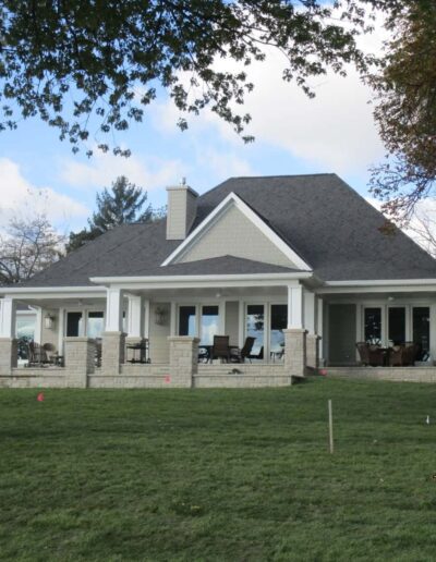 A single-story house with a large porch and a sloping lawn, taken on october 22, 2018.